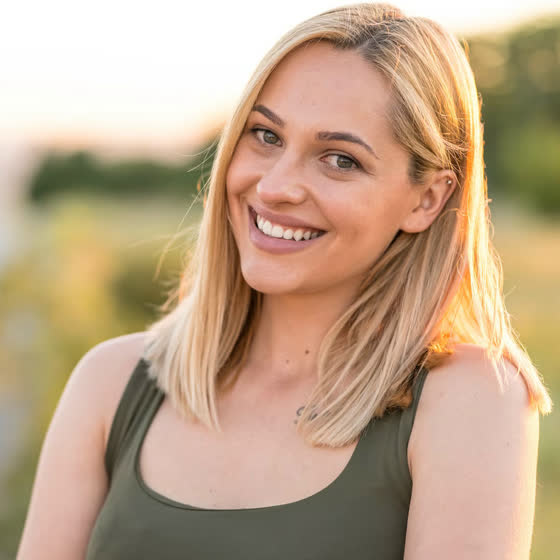 Original photo: portrait of a smiling blonde woman in a green top